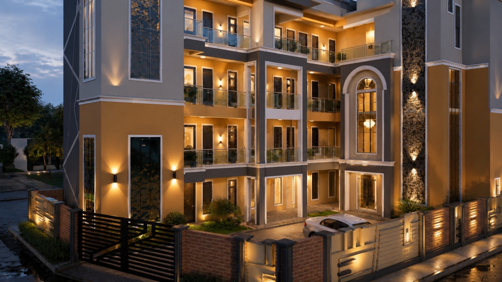 A BANEC residential apartment block lit at dusk under warm elevation lighting.